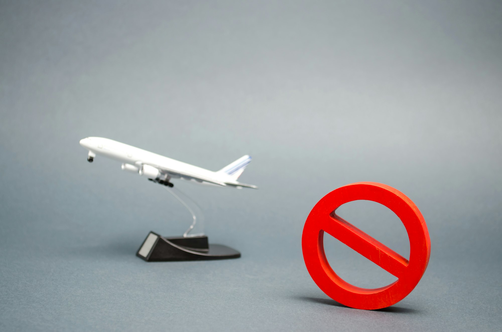 The sign of the ban and a miniature toy aircraft